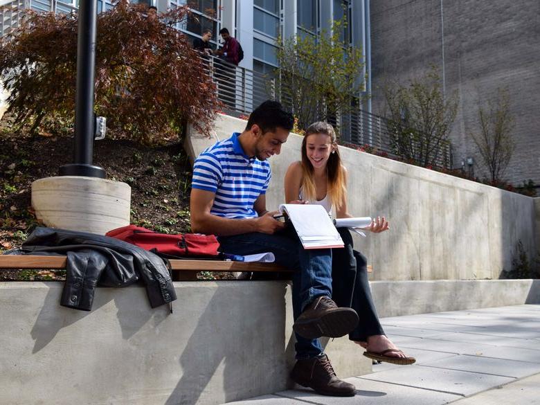 Students sitting on patio reading notes at Penn State Abington near Philadelphia